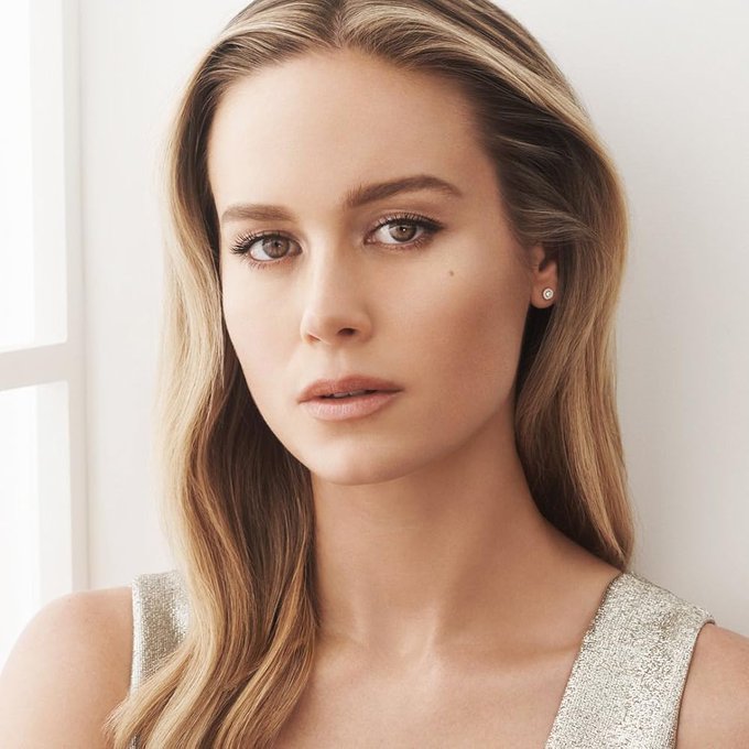 The image features a portrait of Brie Larson, the actress being celebrated for her 37th birthday, showing her with long blonde hair and soft, natural makeup while wearing a shimmering silver top and pearl earrings. The polished headshot complements the celebratory post highlighting her birthday milestone.