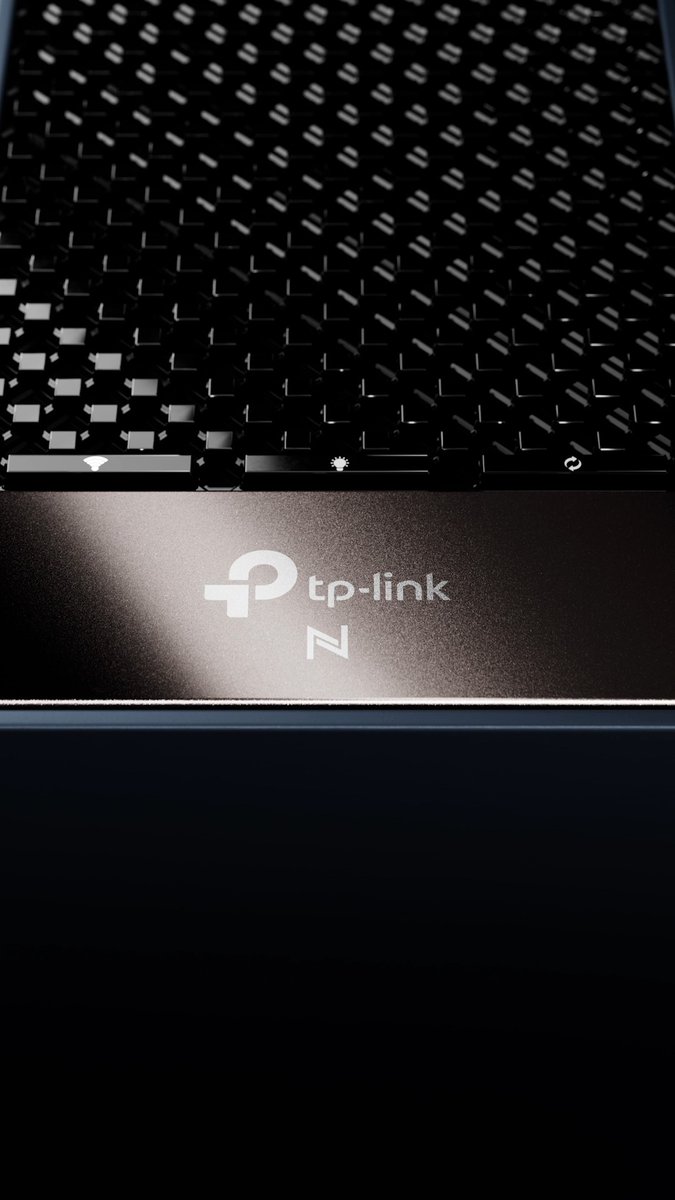 Close-up of a black TP-Link router showing its mesh ventilation grille and status indicator icons (Wi-Fi, WPS, power) above the illuminated brand logo.
