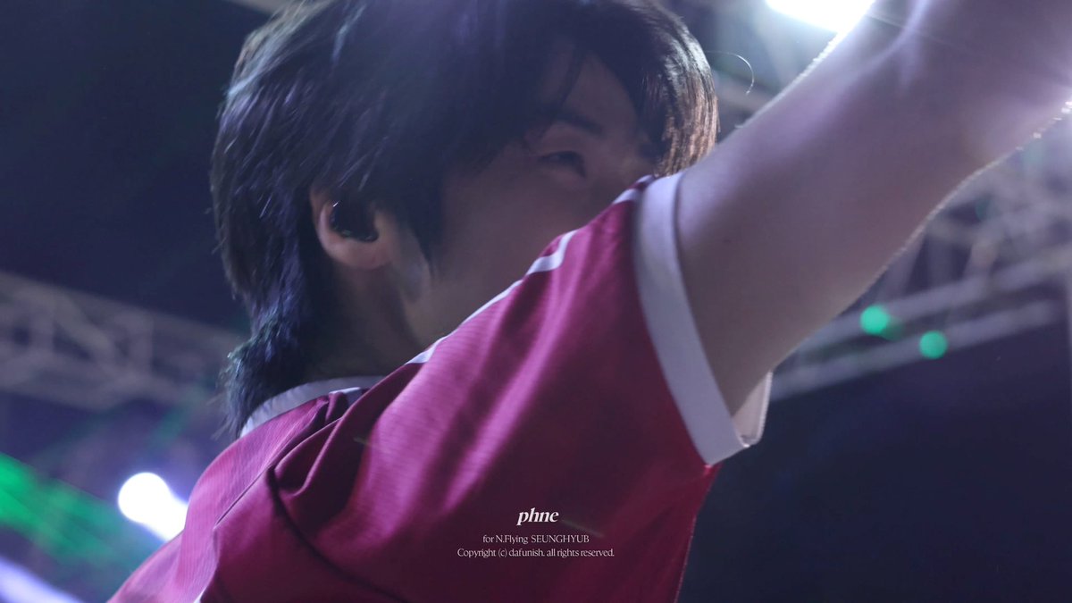 A young man in a maroon jersey performs on stage, captured from a low angle; text reads 'phne for N.Flying SEUNGHYUB Copyright (c) daftunish. all rights reserved.'