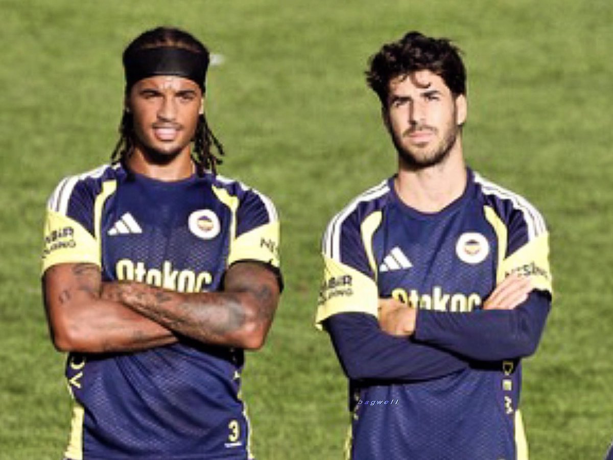 Two men pose with arms crossed on a green field, wearing matching navy and yellow Adidas soccer jerseys featuring the "Otokoc" sponsor logo and the Fenerbahçe club crest. The image complements the post by showcasing two confident-looking players, likely representing the "winning team."