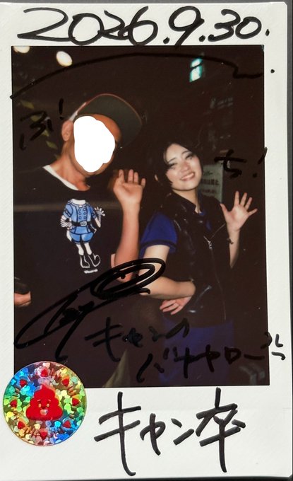An autographed Polaroid dated 2026.9.30 shows a woman waving beside another person whose face is obscured; Japanese writing and a holographic sticker decorate the bottom.
