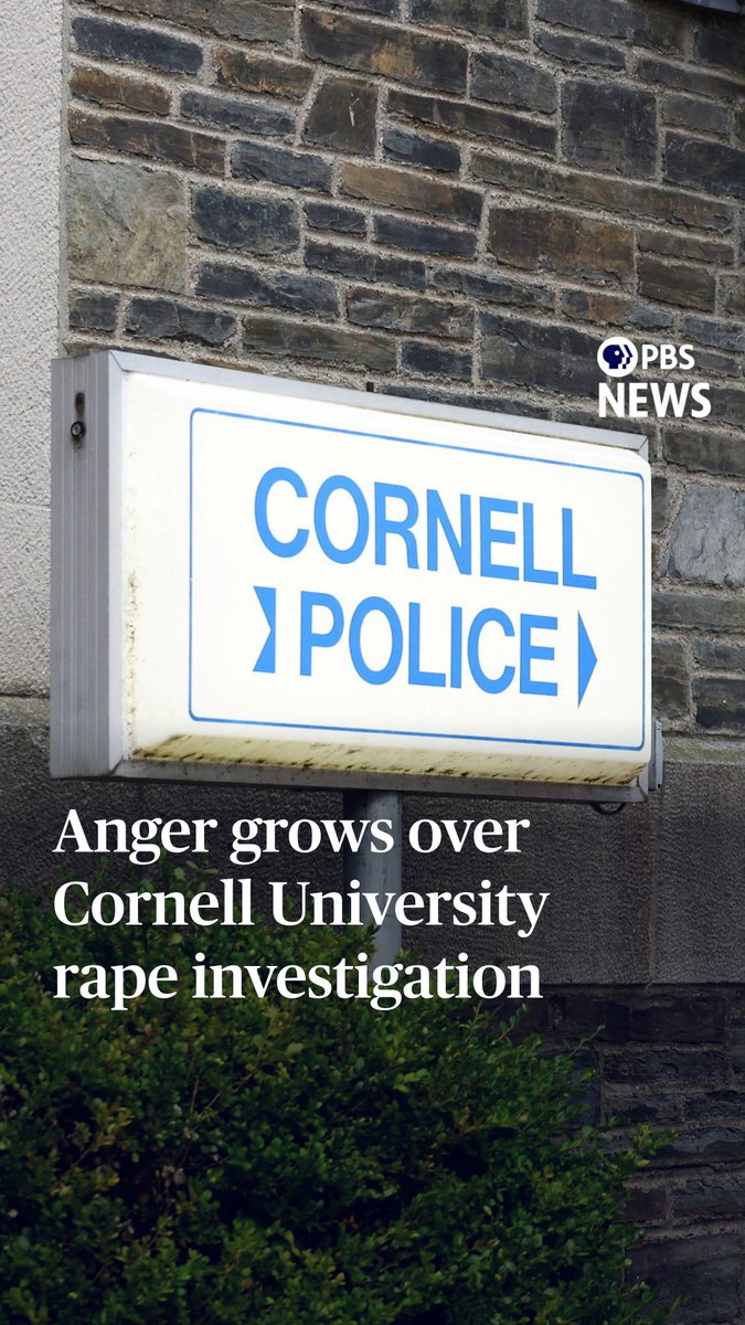 A Cornell Police sign mounted on a stone building is shown, with PBS News branding and text reading "Anger grows over Cornell University rape investigation," highlighting the public backlash surrounding the reopened inquiry into an alleged 2024 gang rape on campus.
