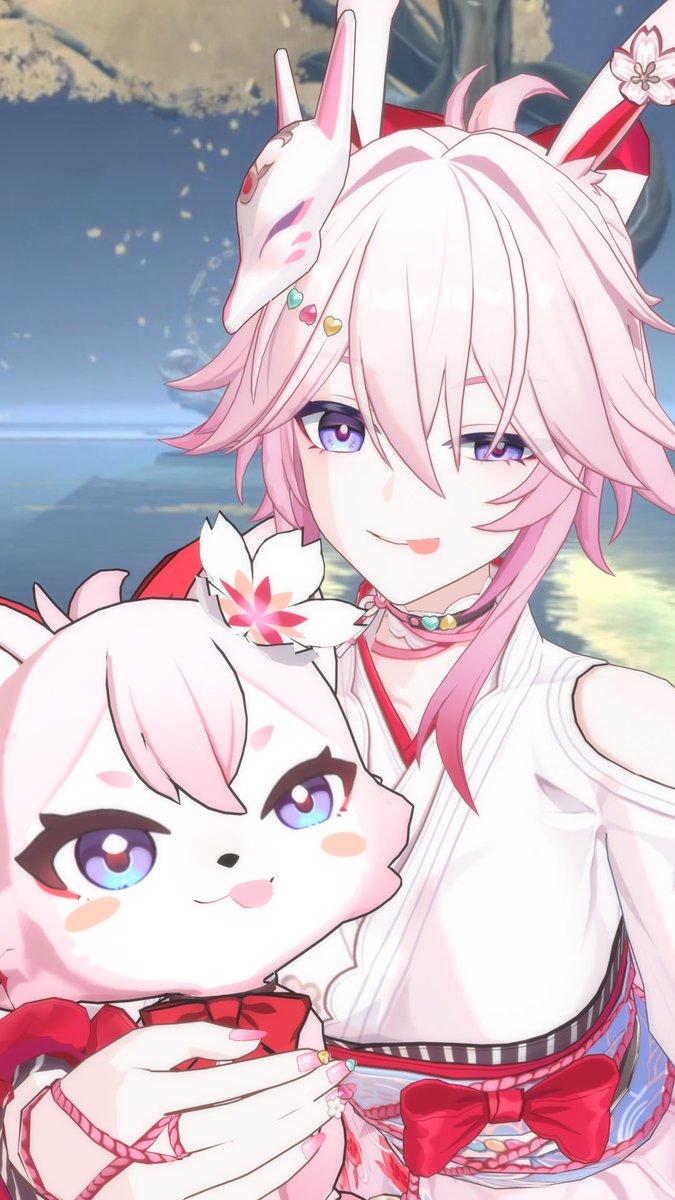 The image depicts an anime-style character with pink hair, fox ears, and a kitsune mask, smiling while holding a small pink-haired plush companion, with cherry blossoms floating in the background—matching the cute, playful ":3" emoticon vibe.