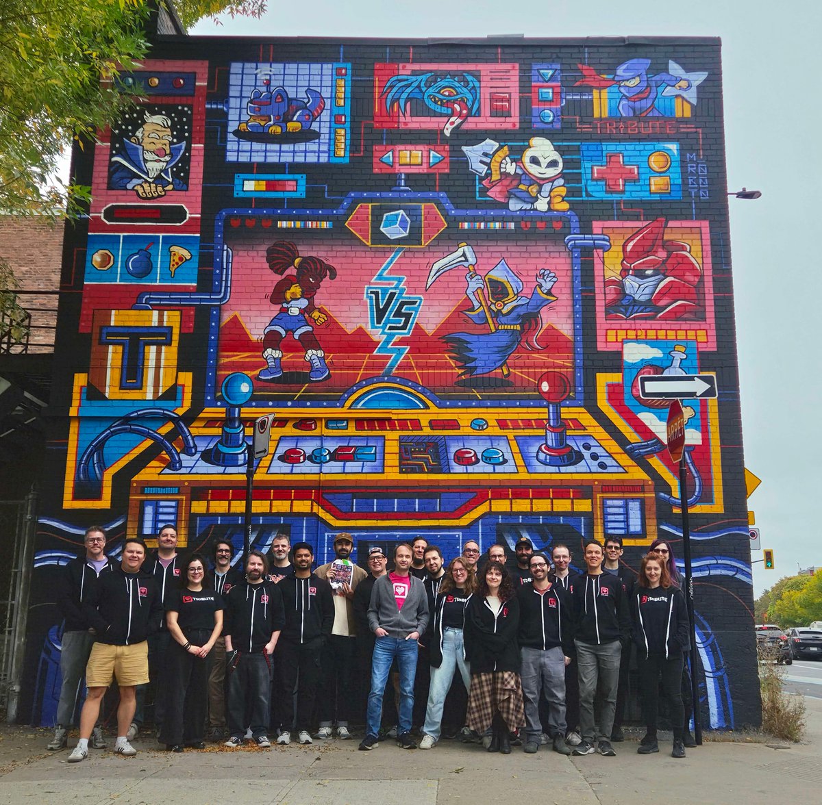 TributeGames's tweet photo. 15 years of making games. We had to put something on the wall. 

To celebrate Tribute Games' 15th anniversary, Montréal-based artist M. Roboto brought this mural to life, turning a simple brick wall into a little piece of our story.

A huge thank you to our team, our past, present and future partners, and everyone who's played a part in these first 15 years.  

Watch it all come together!
❤️ 
#Tribute15 #TributeGames