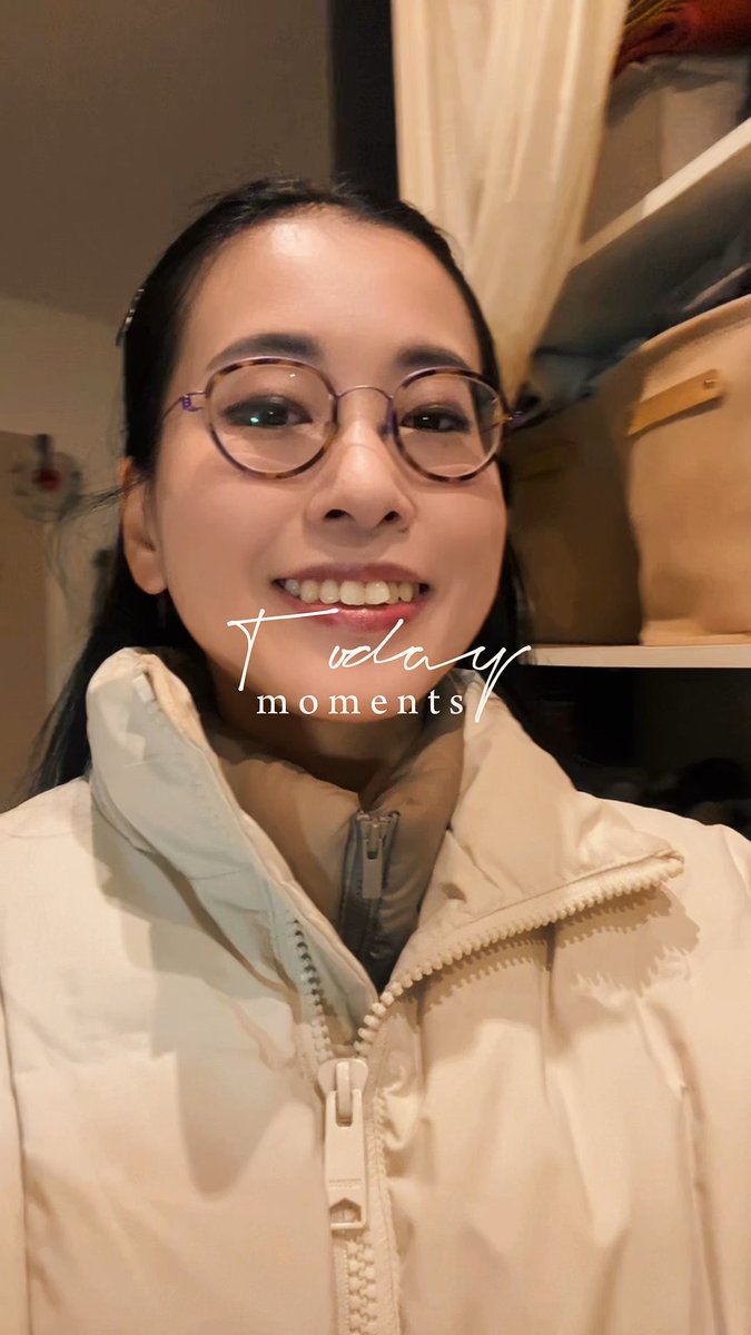 A smiling young woman wearing round glasses and a cream-colored puffer jacket, with the text "Today moments" overlaid on the image.