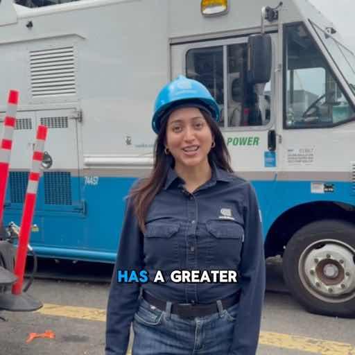 A woman wearing a blue hard hat and dark work shirt smiles in front of a utility truck labeled "POWER," with on-screen text reading "HAS A GREATER," reinforcing the post's message about the workforce driving New York's energy reliability and broader economic impact.