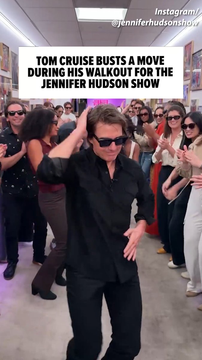 Tom Cruise dances in a black shirt and sunglasses while surrounded by a crowd of people in what appears to be an office hallway, with text stating 'TOM CRUISE BUSTS A MOVE DURING HIS WALKOUT FOR THE JENNIFER HUDSON SHOW'.