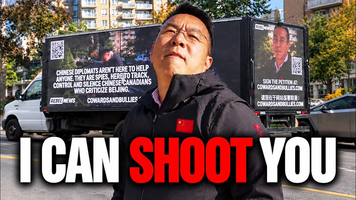 A man in a black puffer jacket with a Chinese flag patch stands in front of Rebel News mobile billboards criticizing Chinese diplomats, with overlaid text reading "I CAN SHOOT YOU".