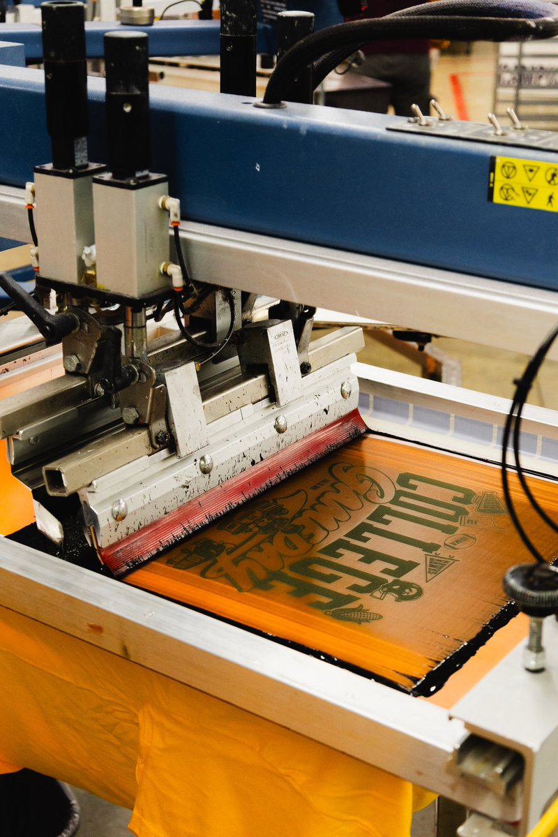 IowaNILStore's tweet photo. Our production facility is churning through College GameDay merch! It’s all headed our way. 

Check out merch at Scheels, Rally House, the Iowa Bookstore and The Black &amp; Gold Shop this weekend. 

If you’re not in the area, shop here: https://t.co/SzJFURezUn https://t.co/VifEreehVZ