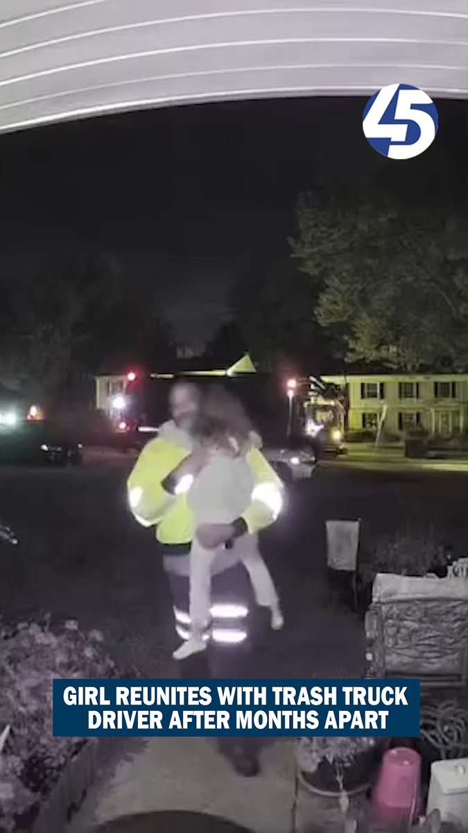 A surveillance camera screenshot showing a person in a high-visibility jacket hugging a small child at night, with a news banner reading 'GIRL REUNITES WITH TRASH TRUCK DRIVER AFTER MONTHS APART'.