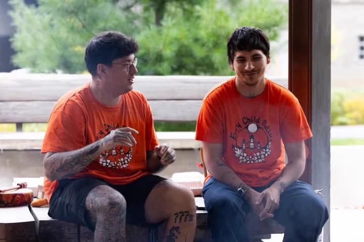 Participants chat at a ceremonial fire held at Ziibiing, an Indigenous teaching and gathering space on the St. George campus