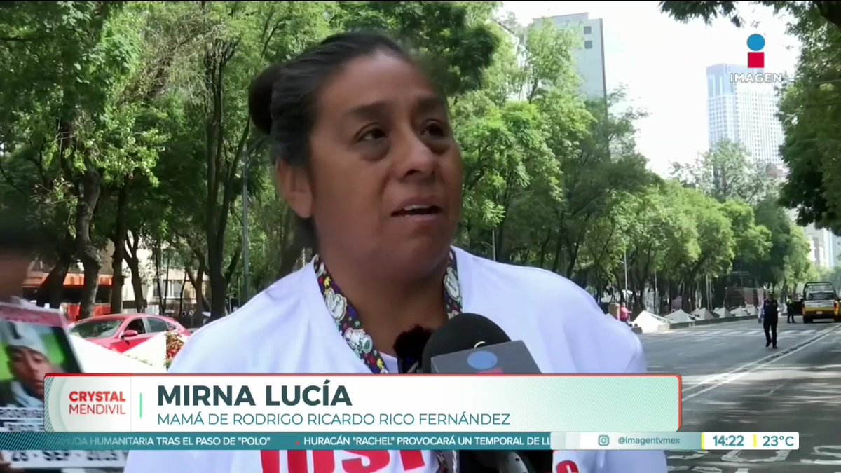 A news interview screenshot from Imagen TV featuring Mirna Lucía, identified as "MAMÁ DE RODRIGO RICARDO RICO FERNÁNDEZ," speaking into a microphone on a tree-lined avenue with a reporter named Crystal Mendivil.