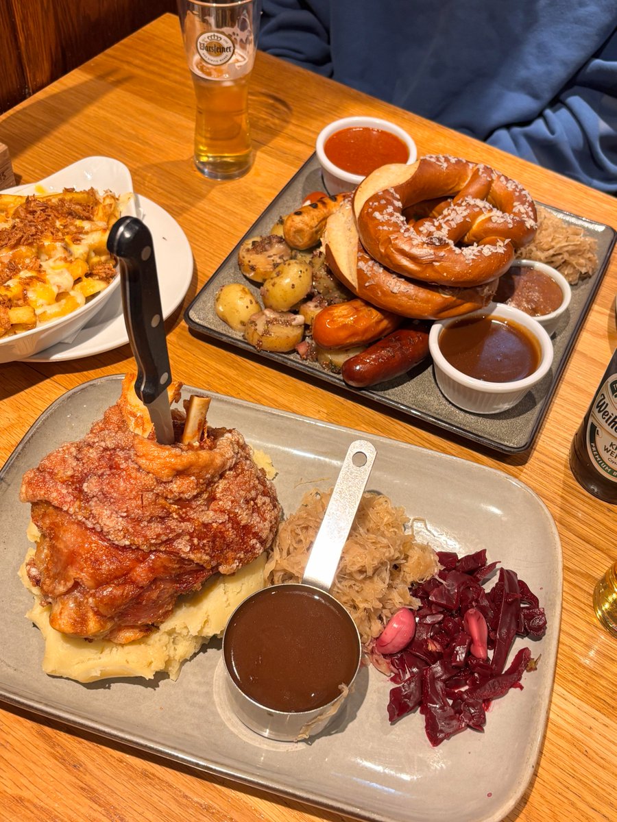 lxpsag's tweet photo. Craving a massive feast?  Just dived into the ultimate German platter—crispy pork knuckle, a mountain of sausages, pretzels, and all the sides. Pure comfort food heaven! Which dish are you grabbing first? https://t.co/IhrSBngfqH