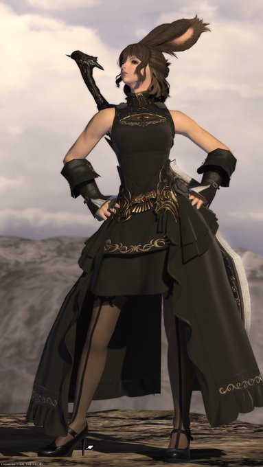 A character from Final Fantasy XIV (appears to be a Viera) standing on a rocky terrain, wearing an ornate black dress with gold accents and gauntlets, with a large weapon strapped to her back.