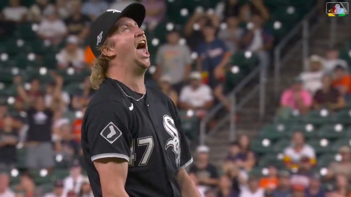A baseball player wearing a Chicago White Sox black jersey with the number 47 yells intensely, looking upward with a passionate expression during a game.