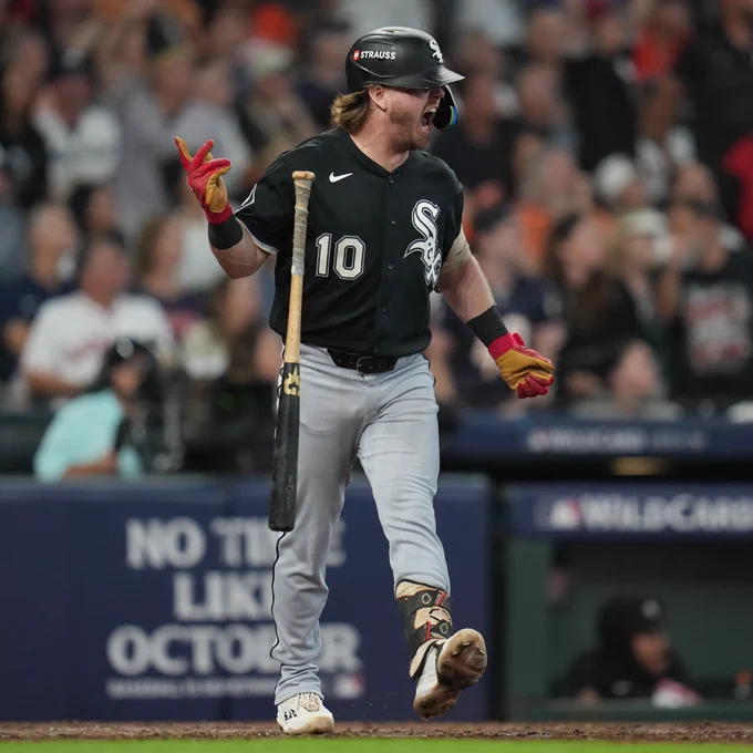 Chase Meidroth screams and flips his bat after hitting a three-run home run in AL Wild Card Game 2. He wears a black Chicago White Sox uniform.