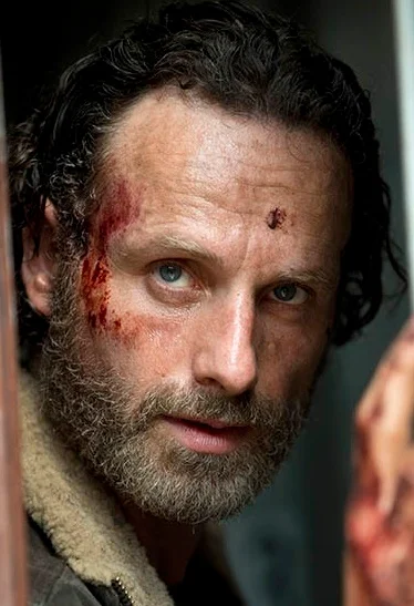 bubs's tweet photo. Then I needed to create the characters sheets for visual reference. I gaveAstra a couple photos of my face and one of Rick Grimes and a an outfit I found. 

"Now I need to create a character sheet for the man. Here are detailed photos of his face. His clothing should be post apocalyptic.. also attached a reference image for the jacket and hood. Reference photo of a man with a beard and blood on his face for beard and dirty face inspiration. Bring that facial hairstyle and facial texture to the man with high res photo pointing a fingure gun and use his exact facial features."
