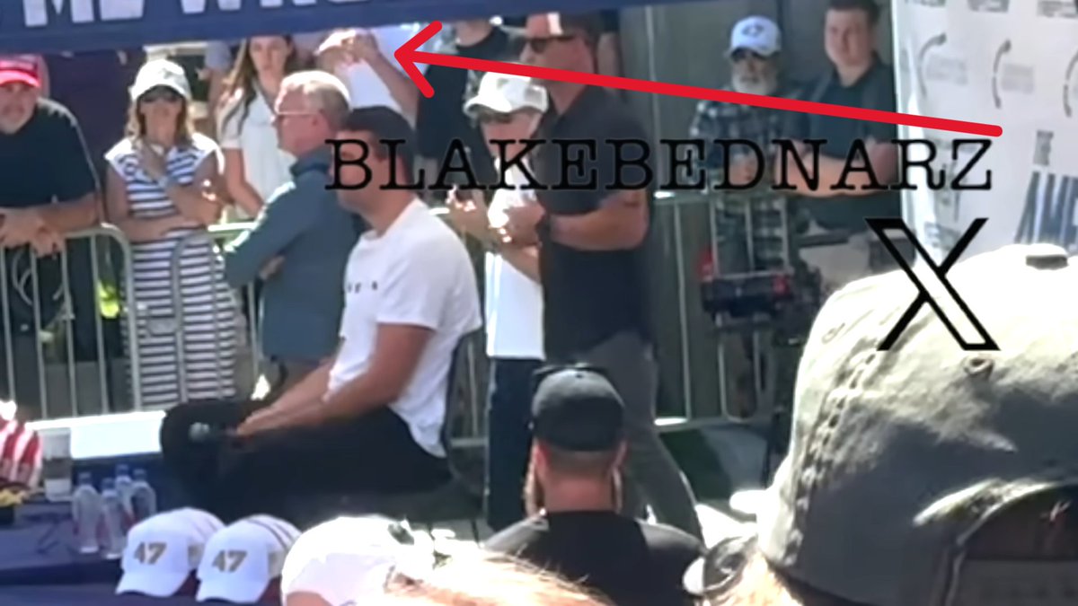 AlexandriaMcCue's tweet photo. Agreed. And it's like, what is this kid in this white t-shirt doing??? It looks like he's signaling out to the perimeter somewhere. 
To me, the first signal seems to indicate that the SM58 mic is now live. 
The second signal with the fists coming together seems to indicate that Charlie is about to grab the live mic with both fists in order to close the circuit. 
And the third signal, which would have been made right after Charlie's hands came together, could hypothetically indicate that the circuit has now been broken. 
This would make sense if Dan's signal at that same moment is, in fact, the signal that mirrors Rick's action of pulling the pin to break the circuit, which would then make the stage much less dangerous (but not quite "safe") for the security team in their little booties to rush in.