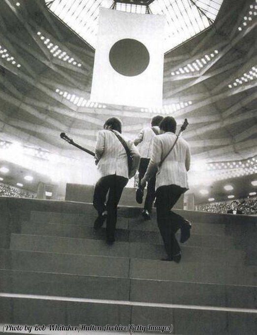 crockpics's tweet photo. The Beatles ascending the stage steps at Tokyo’s legendary Nippon Budokan Hall on June 30, 1966. Marking the very first time a rock-and-roll band was permitted to perform inside the revered national martial arts arena, the Fab Four took the stage under intense security and heavy political scrutiny. Captured from a striking low angle by photographer Robert Whitaker.
 🎸 Because Japanese audiences were remarkably quiet and respectful compared to Western crowds, The Beatles could actually hear their own playing at the Budokan for the first time in years. Do you prefer hearing the raw, screaming crowd energy of Beatlemania or their tighter, quieter live recordings?🎸 👇️