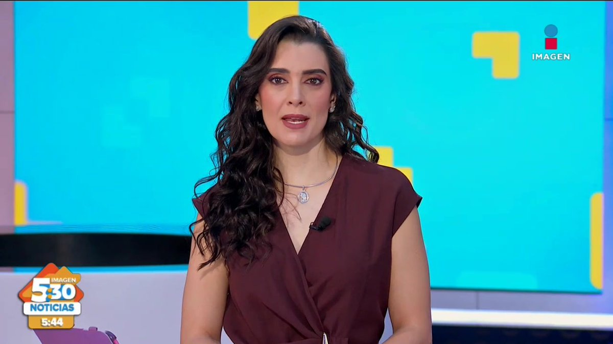 A news anchor with long curly dark hair wearing a burgundy top presents on the '5:30 Noticias' Imagen broadcast, with the time shown as 5:44.