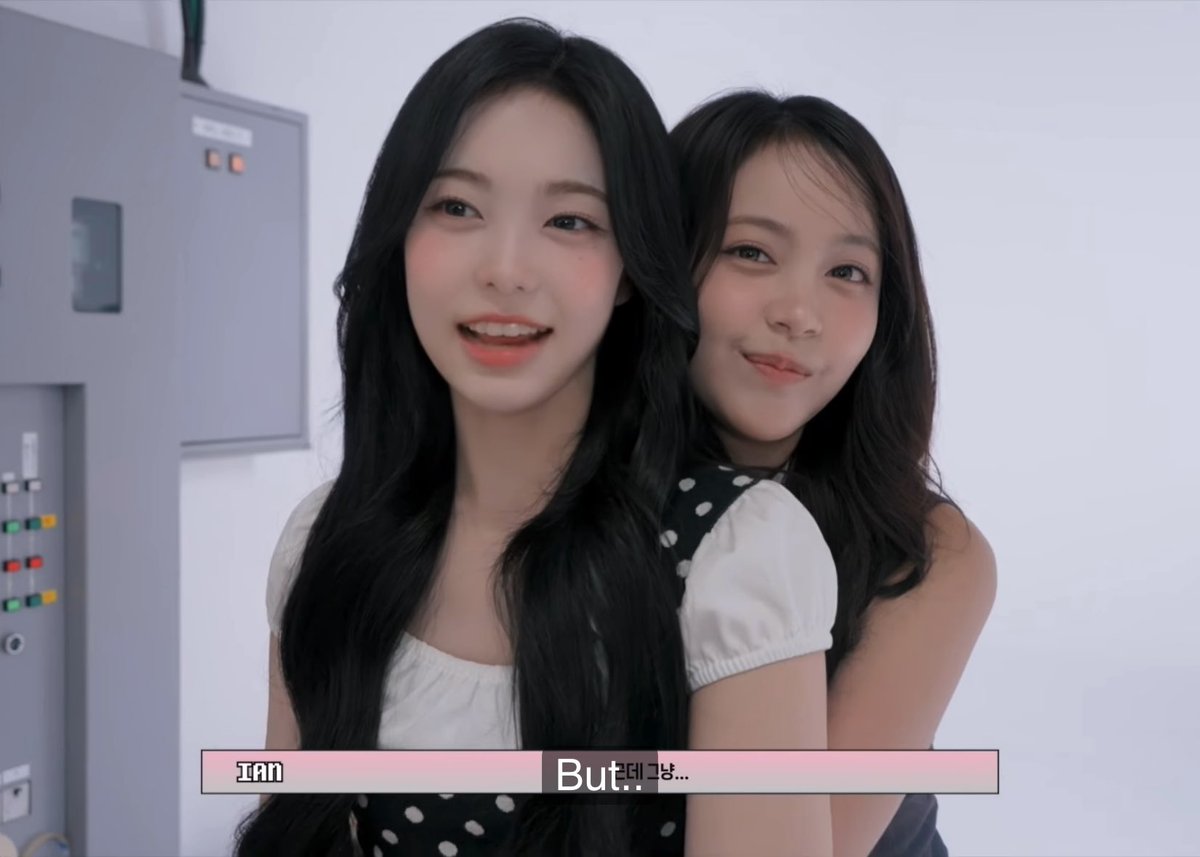 Two young women pose closely for the camera in what appears to be a video vlog, with on-screen text identifying 'Ian' and showing subtitles 'But...태냥...'.