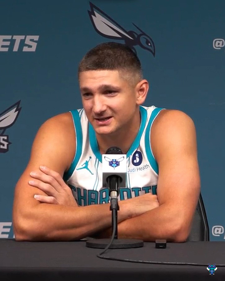 Charlotte Hornets player Grayson Allen sits at a press conference podium wearing his teal and white jersey with "Atrium Health" sponsorship, addressing the media against a Hornets-branded backdrop, aligning with his quote about prioritizing team success over personal recognition.