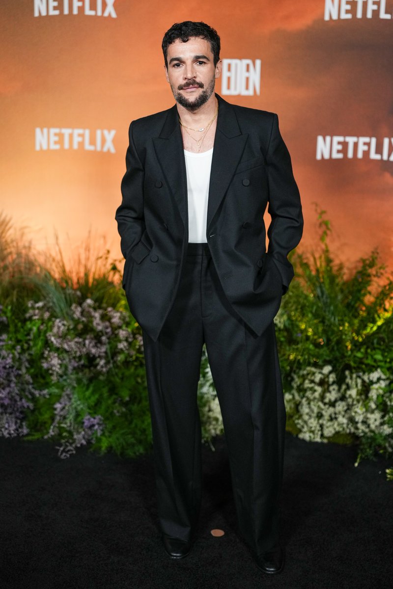 celeb124's tweet photo. Christopher Abbott hit the East of Eden premiere at The Plaza Hotel in New York City in a black double-breasted suit worn open over a white tank and layered gold necklaces. Wide-leg black trousers and polished dress shoes finished the Netflix carpet look. https://t.co/q3npBUB9QQ