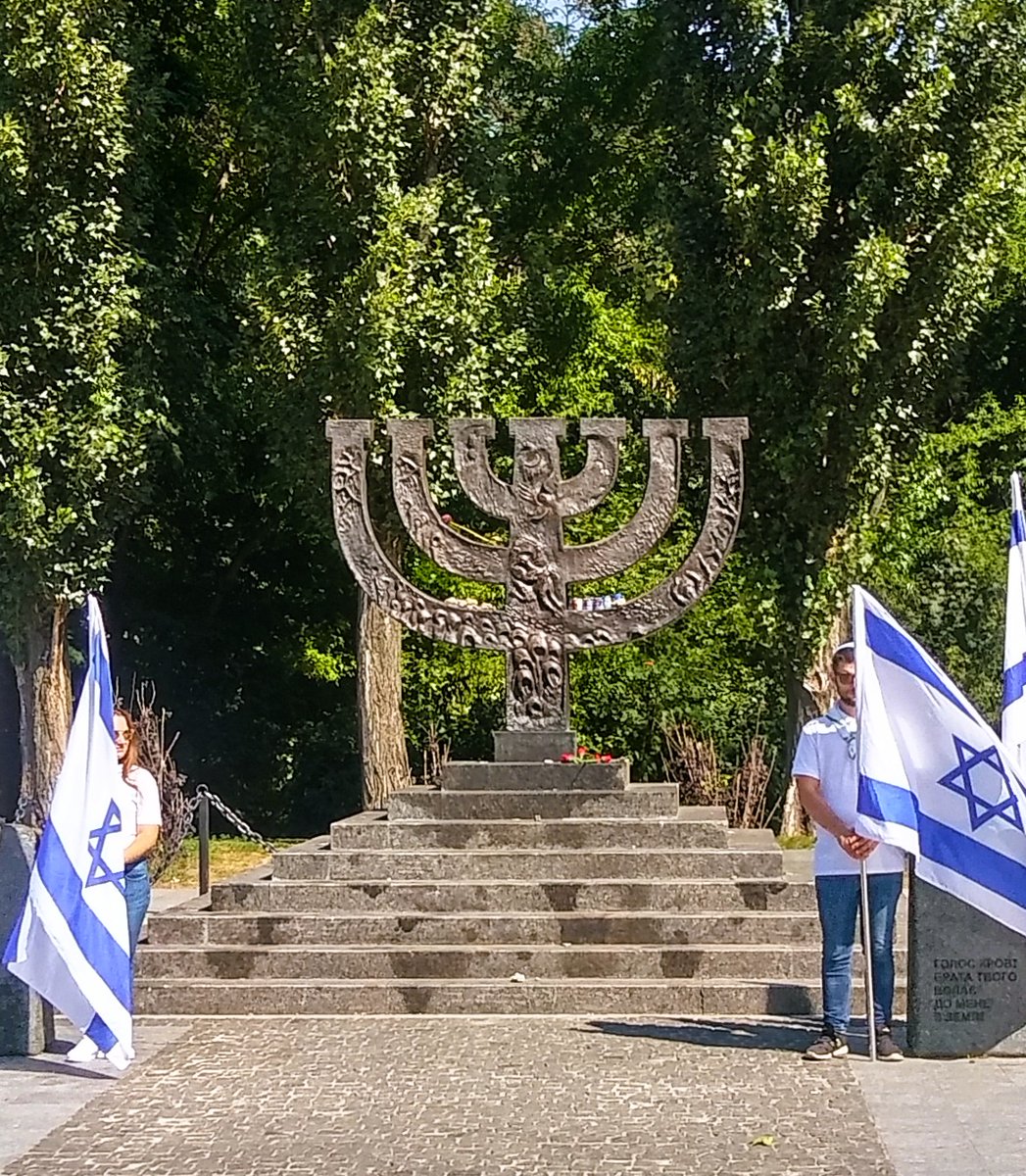 YacovLivne's tweet photo. It started with the Jews. 
Remember Babi Yar, 85 years ago.
In September 1941 the Germans occupied Kiev. The Jews were ordered to assemble “for resettlement.” Marched under guard to Babi Yar, on the outskirts of Kiev, they were forced to hand over all their belongings and then led to a deep ravine and shot. Women, children, the elderly and the young. Everyone. Just for being Jewish.
The massacre was carried out by SS Einsatzkommando 4a, together with German and Ukrainian police units. The bodies of the victims were piled in the ravine. In just two days, September 29–30, at Babi Yar, 33,771 Jews were murdered - one of the largest mass shootings during the Holocaust. 
The number of Jewish victims at Babi Yar eventually exceeded 50,000. Only 29 Jews known to have survived, a ratio of 1:1660. One survival for every 1,660 murdered.
As always, the hate that began with Jews did not end with Jews. In total, more than 100,000 people were murdered at Babi Yar, including Soviet prisoners of war, Roma and Sinti, psychiatric patients, and other innocent civilians. Those who managed to escape were mostly betrayed by local residents.
After the physical annihilation came the attempt to erase the memory. Under “Sonderaktion 1005” the Nazis sought to conceal and destroy evidence of their atrocities. That was not the end.
Efforts to suppress the memory of the Holocaust continued for decades under Soviet rule, as part of the Soviet Union’s antisemitic anti-Zionist political campaign. So the first memorial erected at Babi Yar in 1974 did not mention the Jews.
Only after the collapse of the Soviet Union in 1991 was the Menorah Monument erected, at the edge of the Babi Yar killing pit, in memory of the Jewish victims.
Today we promise: Never again.

Photos: 1. Babi Yar, October 1941, German soldiers rummaging through the clothes of murdered Jews (pic: Yad Vashem). 2. The Menorah at Babi Yar.