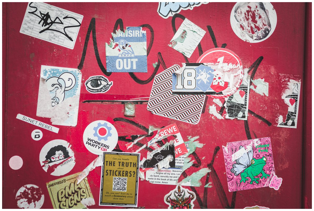 leo1855's tweet photo. Phone Box Sticker Graffiti. Taken on a walk through Sheffield city centre, this phone box stopped me in my tracks. I loved the chaos of it, layer upon layer of stickers, scraps, tags and half-torn messages all fighting for space on the same red https://t.co/mMhgdf04GP