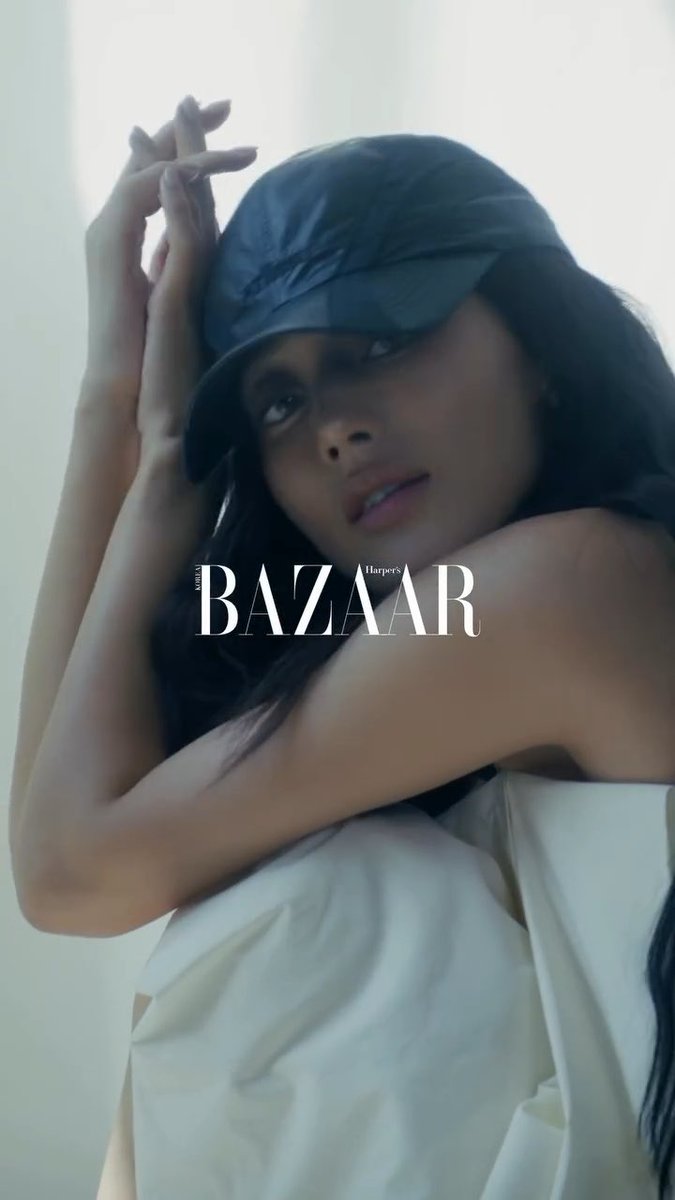 A stylish portrait features JIHYO wearing a navy bucket hat and a white top, posing with her arms raised near her face. The image is overlaid with the "Harper's Bazaar" logo, corresponding to the Harper's Bazaar Korea editorial feature mentioned in the caption.