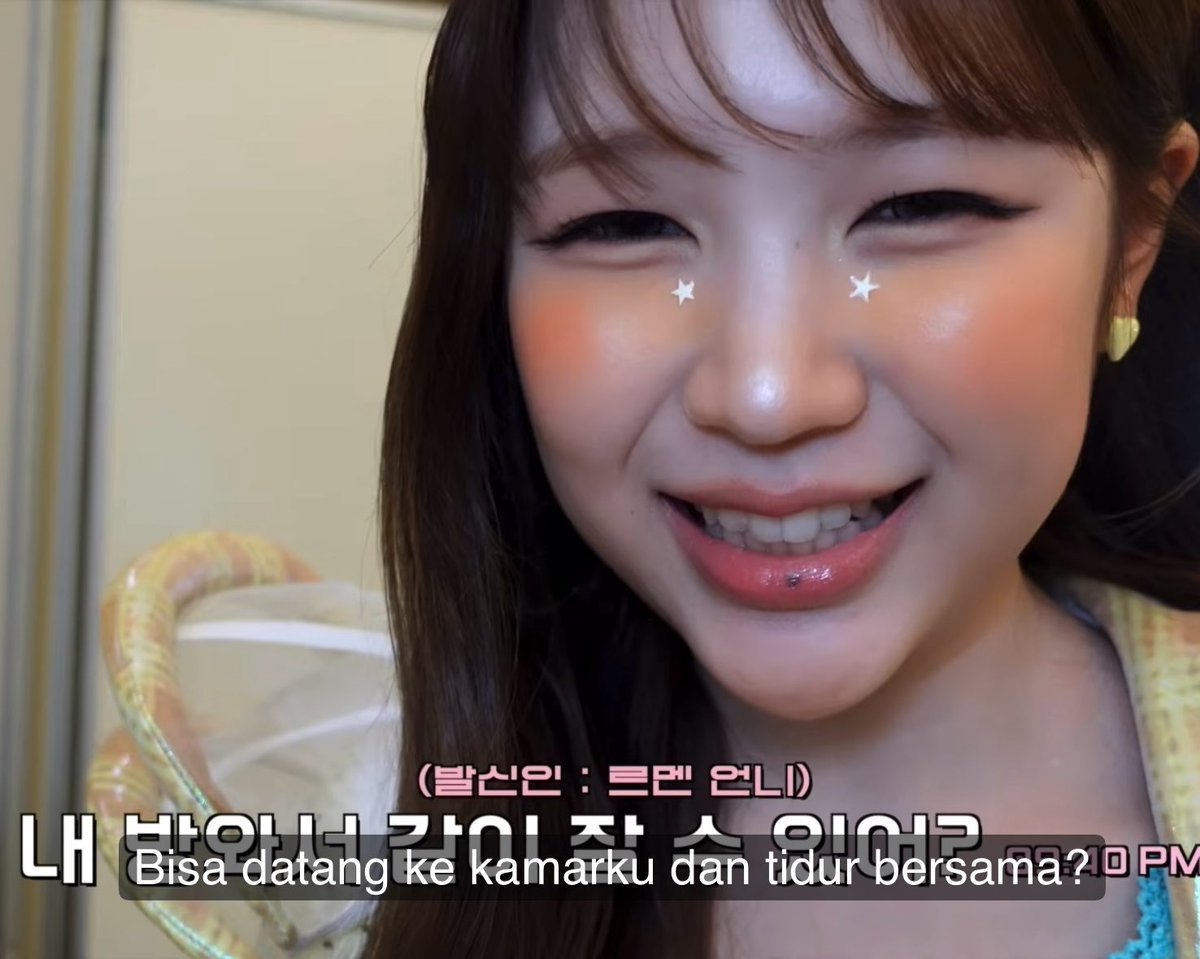 A woman with star stamps and red lipstick looks off to the side while smiling, with Korean subtitles reading "내 방와서 같이 잘 수 있어?" and an Indonesian translation "Bisa datang ke kamarku dan tidur bersama?" meaning "Can you come to my room and sleep together?"