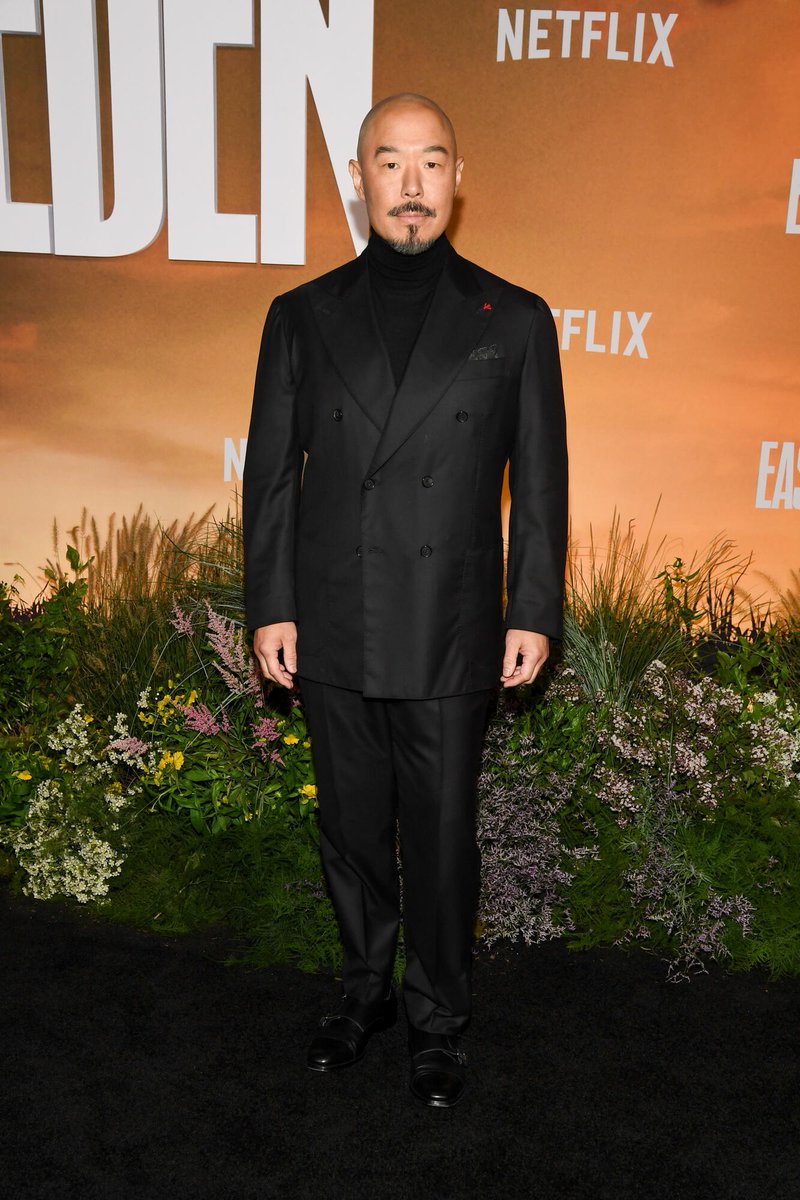 celeb124's tweet photo. Hoon Lee hit the East of Eden premiere at The Plaza Hotel in New York City in a black double-breasted suit over a black turtleneck with a red lapel pin. Polished black monk-strap shoes finished the Netflix carpet look. https://t.co/9frcsE8rrj