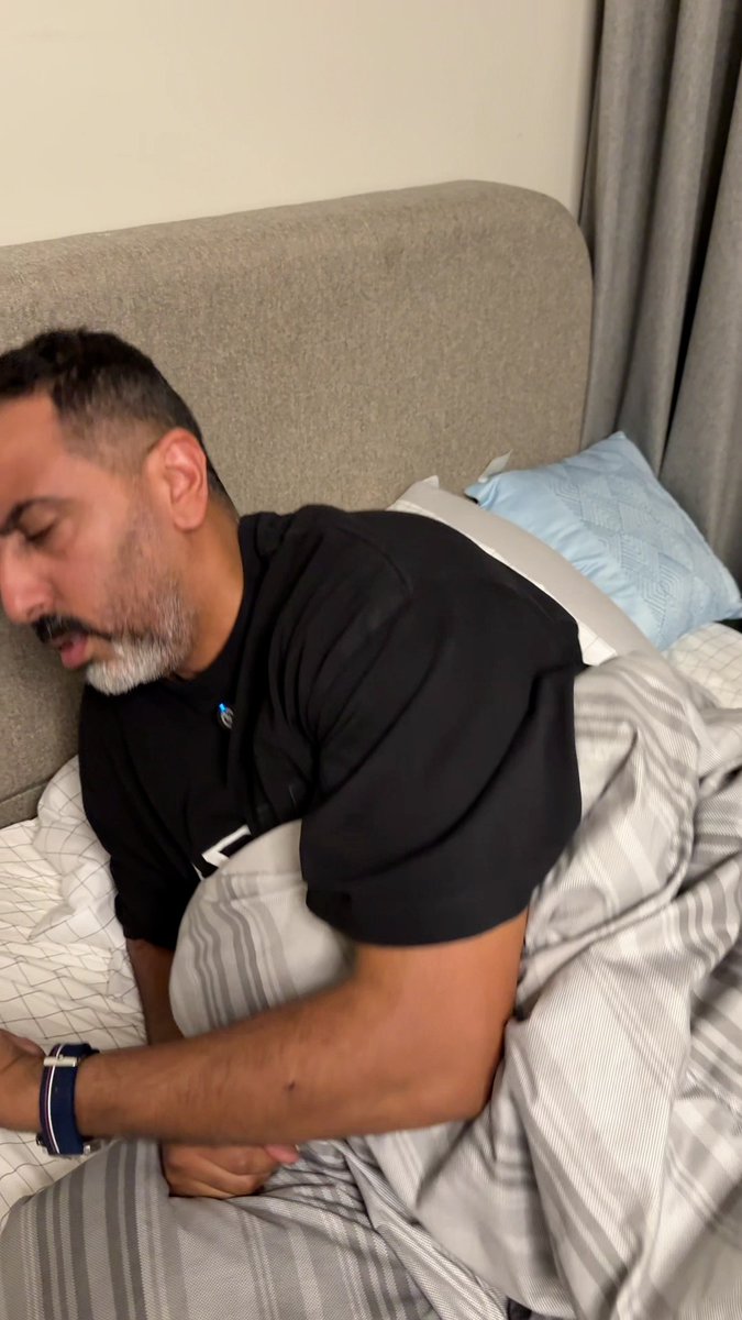 The man appears to be sleeping so deeply in bed that he's completely missed the exciting deals being advertised, highlighting how tempting they are to wake up for.