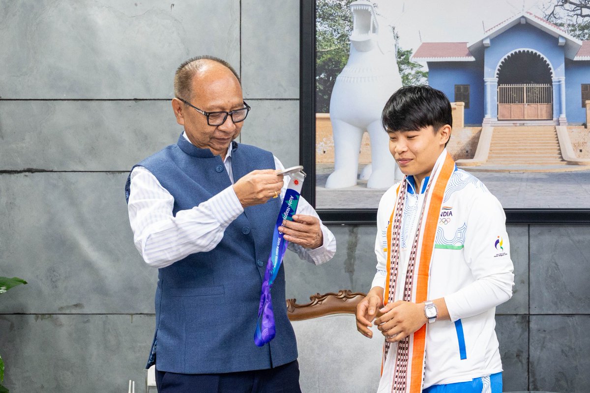YKhemchandSingh's tweet photo. Met India's star weightlifter, Km. Saikhom Mirabai Chanu, who won a silver medal in the women's 48 kg category and elite Indian Wushu Sanda fighter, Km. Naorem Roshibina Devi, who won a silver medal in the women's Sanda 60 kg category at the Aichi-Nagoya Asian Games 2026 in Japan, at my Secretariat, Mantripukhri, today. 

Mirabai lifted 87 kg in snatch and 111 kg in clean and jerk, with a total lift of 198 kg, to clinch the silver medal. Roshibina has created history by winning medals at three consecutive Asian Games, bronze in 2018, silver in 2023 and 2026, becoming the first Indian woman to achieve this feat in Wushu.

I extend my heartiest congratulations to both players for once again making the entire country and the State proud. Their hard work, discipline and perseverance continue to be an inspiration for all young sportspersons in the country, especially the youth of Manipur.

The State Government will continue to extend all possible support to sportspersons to promote sports in the State and I wish them continued success in the future.