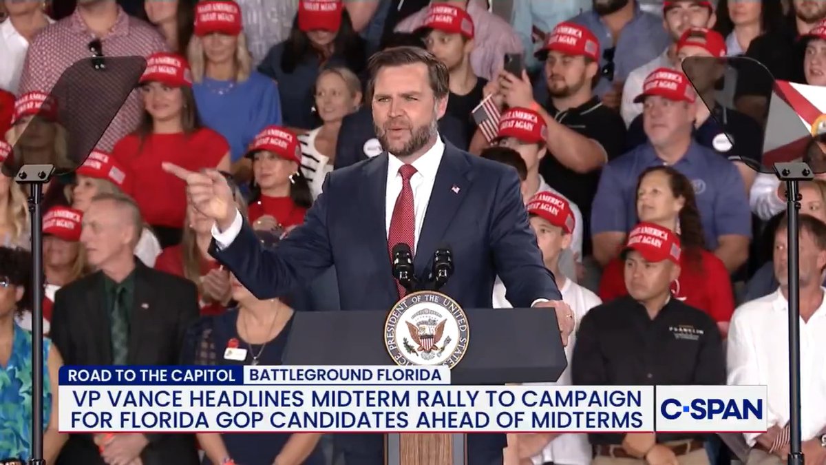 A still image from a C-SPAN broadcast shows Vice President JD Vance speaking at a podium bearing the Vice Presidential seal, in front of a crowd wearing "Make America Great Again" red hats, with a banner stating "Road to the Capitol - Battleground Florida: VP Vance headlines midterm rally to campaign for Florida GOP candidates ahead of midterms." The image contrasts with the accompanying post's conspiratorial claim about Vance's relationship to Peter Thiel and Elon Musk, while the chyron supports the second portion of the post showing Vance's remarks about removing protesters and Democrats.