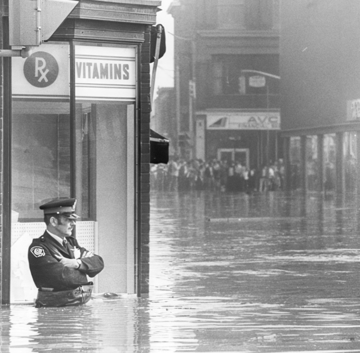WRPSToday's tweet photo. A look back at policing in Cambridge in 1974.

This photo captures a Cambridge police officer standing watch during the city's flooding more than 50 years ago.

The uniform and the streets may have changed, but the commitment to serving the community remains the same.

#ThrowBackThursday