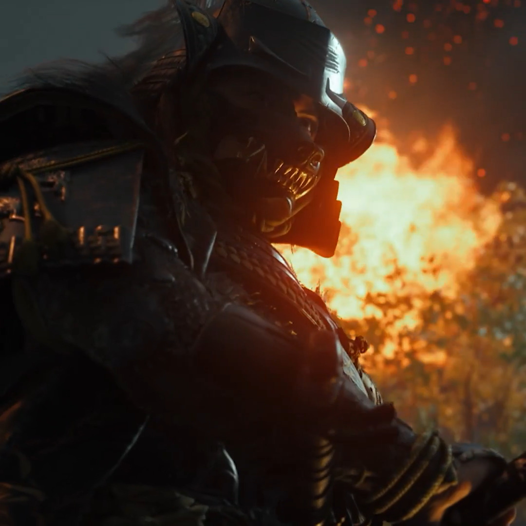 A menacing samurai in dark, ornate armor and a fearsome demon mask stands in profile against a roaring backdrop of flames and embers. The fiery scene evokes the intense samurai combat of *Ghost of Yōtei*, suggesting the first action many players will take—hunting down the Yōtei Six.