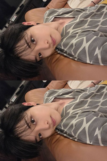 A young man with dark hair poses for a selfie in a patterned gray shirt, shown in a mirrored/duplicated layout. The relaxed, casual setting and slightly tousled hair align with the post's mention of enjoying a hot spring.