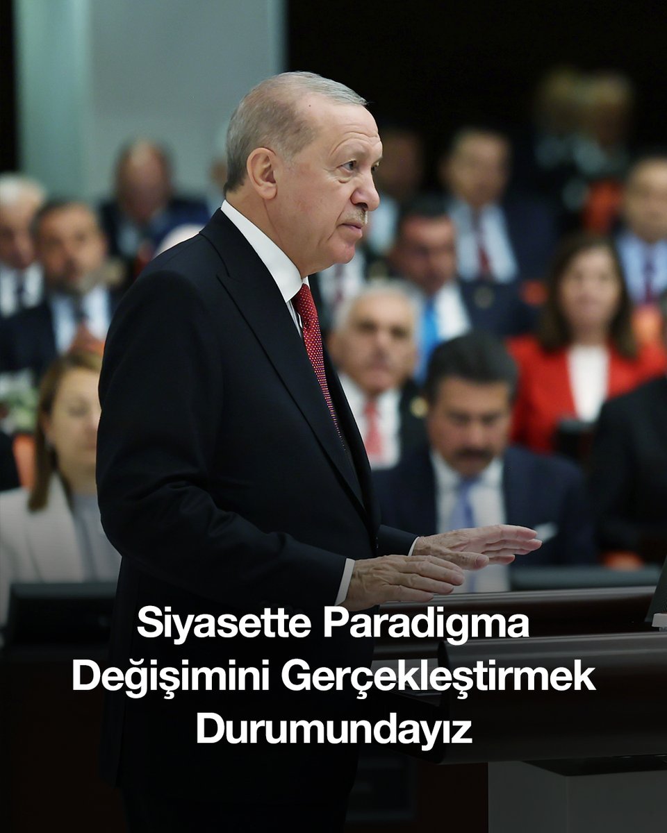 Turkish President Recep Tayyip Erdoğan speaking at a podium with text reading 'Siyasette Paradigma Değişimini Gerçekleştirmek Durumundayız' (We are in a position to realize a paradigm shift in politics).