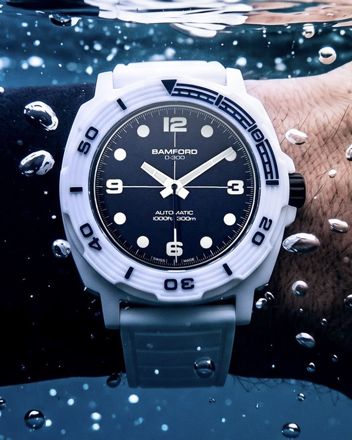 aBlogtoWatch's tweet photo. Bamford London has no shortage of unique, diverse releases in its back catalogue, but the independent British brand has never produced its own dedicated, fully purpose-built diver. 

Until now. The Bamford London D-300 isn’t just a professional-grade diving timepiece, it’s a statement of style that could only come from Bamford London.

Bamford fans will recognize the 42mm wide cushion case form that anchors the Bamford London D-300, as the general silhouette draws its inspiration from the best-selling Bamford London GMT, with a twist — a show-stopping gloss white ceramic finish.

The D-300’s solid ceramic rotating bezel extends the material’s enduring color and scratch resistance to the very edge of the watch, creating a seamless finish with the ceramic case. With a grooved, engraved surface and a partial fill in glossy navy blue, this all-ceramic bezel makes a bold statement with a heavy gear-toothed edge that doesn’t compromise on performance. 

As the brand’s first-ever purpose-built dive watch, Bamford London pushed the D-300 to 300 meters — going above and beyond many of its more established competitors.

Bamford London carries its iconoclastic style over to the D-300’s dial. Bold, wide Arabic numerals join classic circular markers at the hours, while the hands are wide, tapering lume-filled white batons. Rather than simple black, the dial surface itself is a deep, nuanced matte midnight blue, contrasting with the case with a look reminiscent of frigid Arctic waters. 

Bamford London powers the D-300 with either the ETA 2824-2 or the Sellita SW200-1. Both are dependable Swiss-made automatic power plants, with solid accuracy and an ease of servicing that should make long-term ownership of the D-300 a breeze.

Since its inception in 2009, Bamford London has consistently delivered striking, distinctive visual statements for the wrist. The Bamford London D-300 combines a dynamic, ultra-light ceramic presentation, creating a piece that’s equally well suited for the nightclub as the ocean depths.

Discover the Bamford London D-300 now on aBlogtoWatch.

#SponsoredPost