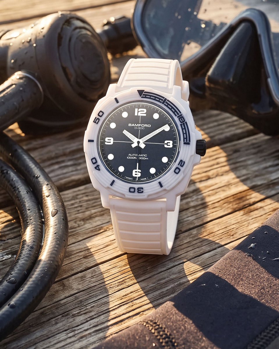 aBlogtoWatch's tweet photo. Bamford London has no shortage of unique, diverse releases in its back catalogue, but the independent British brand has never produced its own dedicated, fully purpose-built diver. 

Until now. The Bamford London D-300 isn’t just a professional-grade diving timepiece, it’s a statement of style that could only come from Bamford London.

Bamford fans will recognize the 42mm wide cushion case form that anchors the Bamford London D-300, as the general silhouette draws its inspiration from the best-selling Bamford London GMT, with a twist — a show-stopping gloss white ceramic finish.

The D-300’s solid ceramic rotating bezel extends the material’s enduring color and scratch resistance to the very edge of the watch, creating a seamless finish with the ceramic case. With a grooved, engraved surface and a partial fill in glossy navy blue, this all-ceramic bezel makes a bold statement with a heavy gear-toothed edge that doesn’t compromise on performance. 

As the brand’s first-ever purpose-built dive watch, Bamford London pushed the D-300 to 300 meters — going above and beyond many of its more established competitors.

Bamford London carries its iconoclastic style over to the D-300’s dial. Bold, wide Arabic numerals join classic circular markers at the hours, while the hands are wide, tapering lume-filled white batons. Rather than simple black, the dial surface itself is a deep, nuanced matte midnight blue, contrasting with the case with a look reminiscent of frigid Arctic waters. 

Bamford London powers the D-300 with either the ETA 2824-2 or the Sellita SW200-1. Both are dependable Swiss-made automatic power plants, with solid accuracy and an ease of servicing that should make long-term ownership of the D-300 a breeze.

Since its inception in 2009, Bamford London has consistently delivered striking, distinctive visual statements for the wrist. The Bamford London D-300 combines a dynamic, ultra-light ceramic presentation, creating a piece that’s equally well suited for the nightclub as the ocean depths.

Discover the Bamford London D-300 now on aBlogtoWatch.

#SponsoredPost