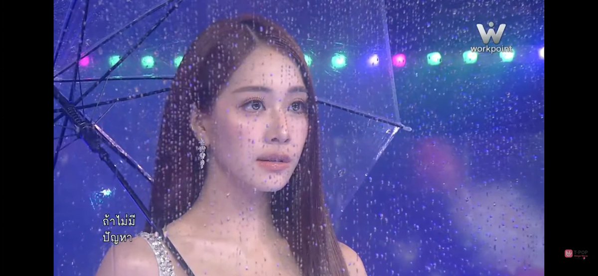 A woman stands in the rain with a clear umbrella, with Thai subtitles "ถ้าไม่มีปัญหา" and a "workpoint" logo visible in the corner.