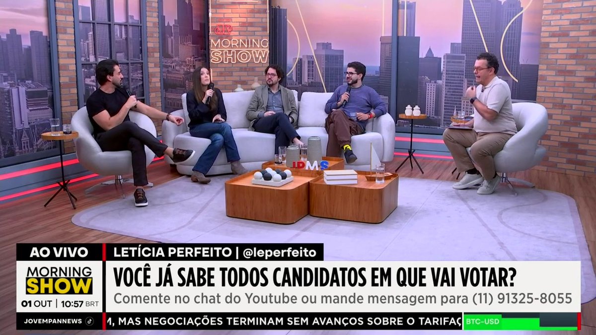 Brazilian Morning Show panel with host Letícia Perfeito discussing voting candidates, with the chyron 'VOCÊ JÁ SABE TODOS CANDIDATOS EM QUE VAI VOTAR?' and a ticker showing BTC-USD.