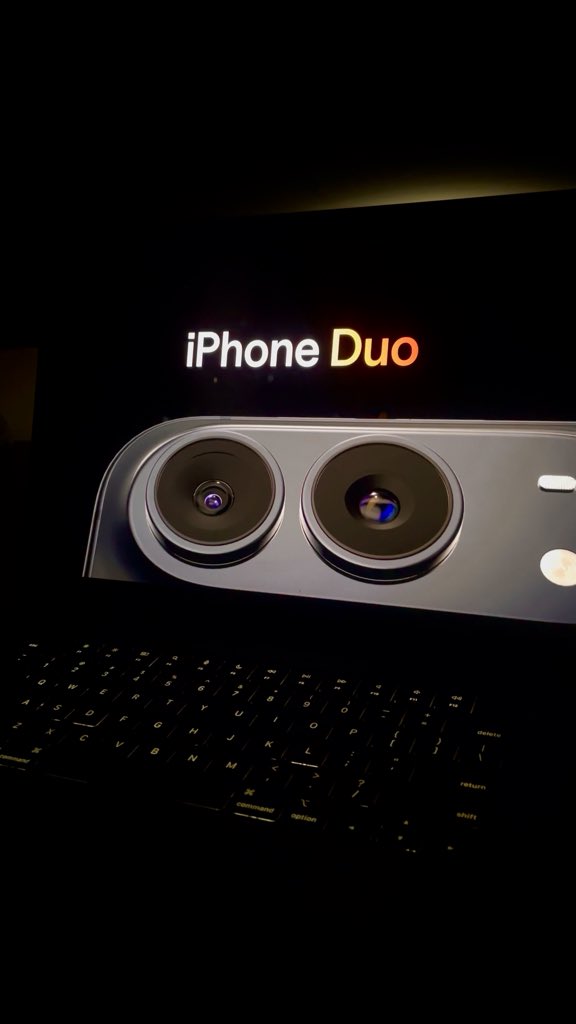 A promotional image of the 'iPhone Duo' concept, featuring two camera lenses on a silver device above a black keyboard against a dark background.