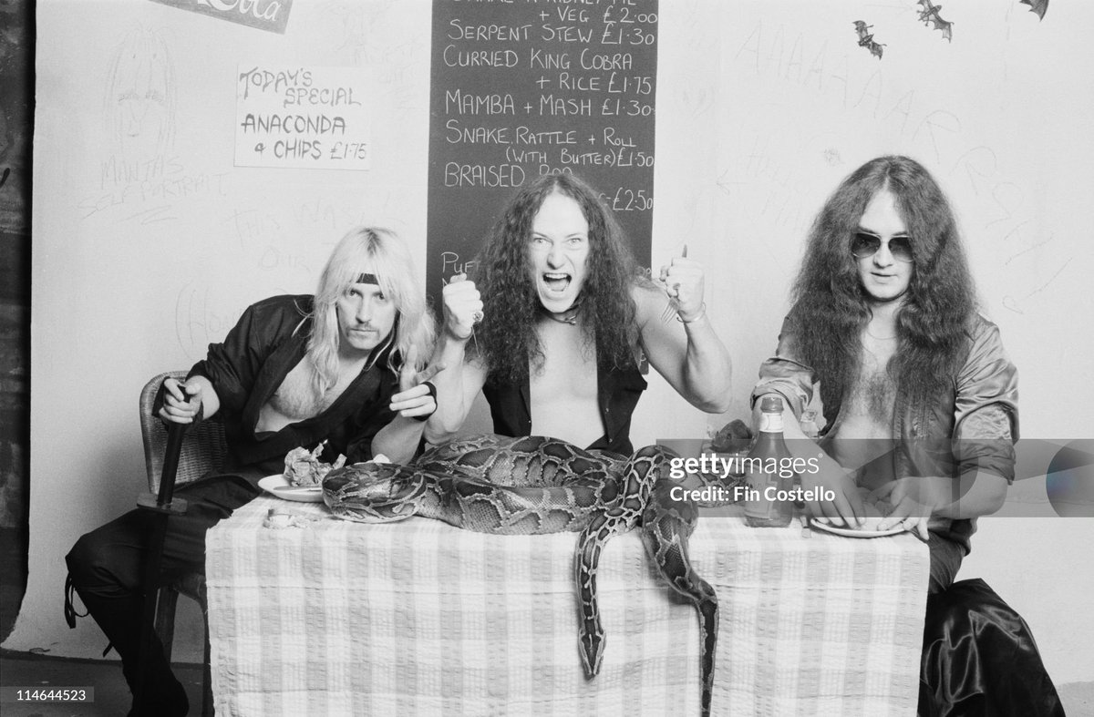 shitbritishpics's tweet photo. Conrad 'Cronos' Lant from Heavy Metal band Venom posed with snakes on a cafe table in London (1985) https://t.co/IFz25txzd7