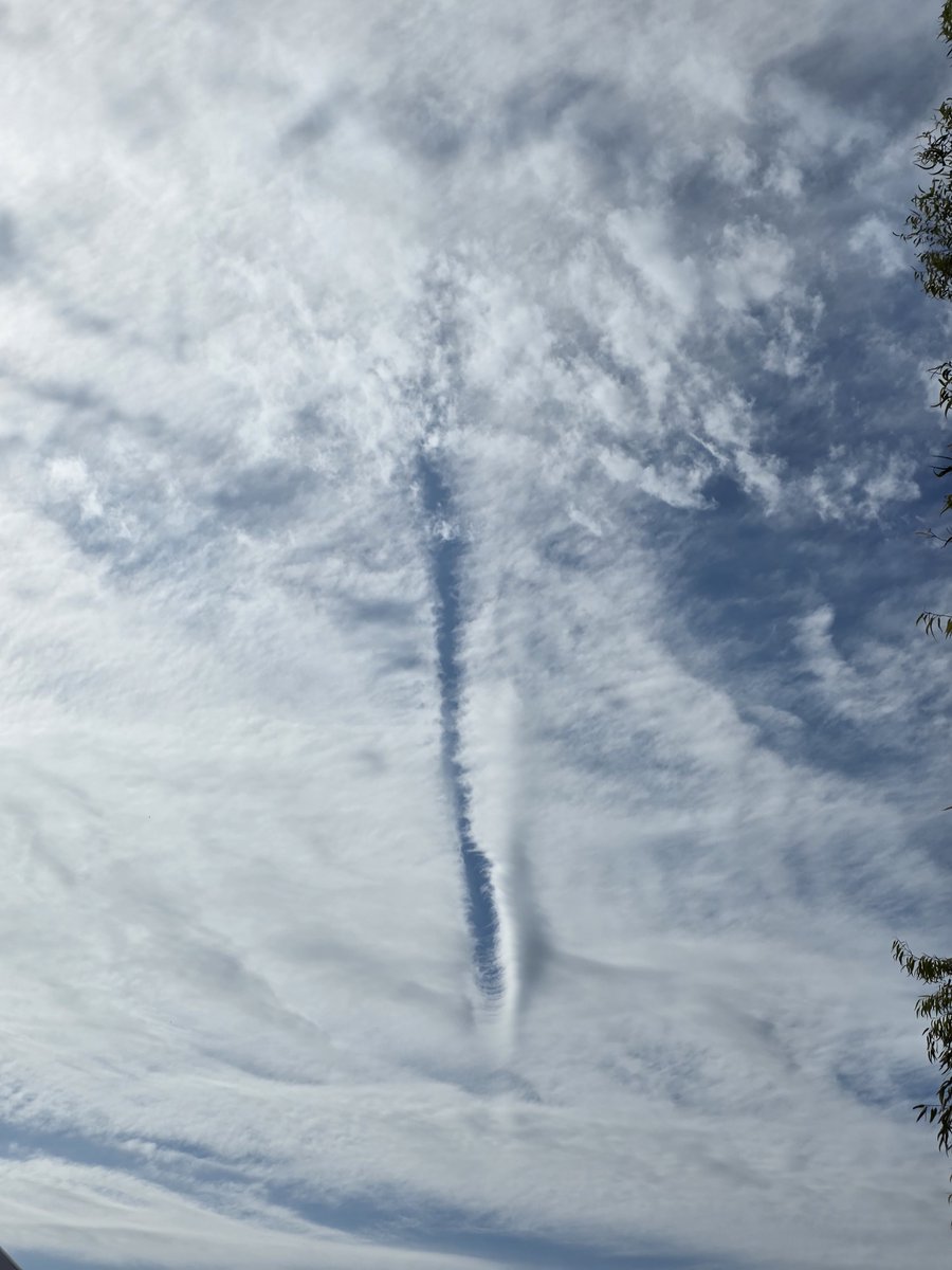 SaMMastOff's tweet photo. A Zipper in the Sky: Rare Physics or Something More?

At first glance, what we see here is a known atmospheric phenomenon—a dissipation trail (or distrail). In classical meteorology, it occurs when an aircraft flies through a thin layer of clouds, where its engine heat and wing turbulence evaporate supercooled water droplets, carving a clear blue channel through the cloud deck.

However, a closer look reveals several puzzling anomalies. The scale of the gap seems entirely out of proportion for a conventional airliner: it is far too wide and voluminous for a relatively small aircraft body. Furthermore, this "cut" lacks typical entry and exit paths—the trail begins and ends abruptly right in the middle of the sky canvas, without a long lead-in or exit tail.

Stepping outside standard explanations to consider an interaction with an unidentified object, these details form an intriguing picture:

1. Local Impulse or Gravitational Rupture: The rift resembles the trajectory vector of an object moving at extreme velocity, where localized shifts in pressure or temperature instantly dispersed the clouds along its path. The absence of a long entry/exit trail suggests a point-source or instantaneous interaction—as if an object materialized at that precise location, exerted a force on the atmosphere, and altered its trajectory or state.

2. Large-Scale Field Footprint: Because the gap vastly exceeds the dimensions of a standard aircraft, it resembles the footprint of a force or energy field surrounding a large object operating under optical concealment (stealth). While the craft itself remains invisible, its energy boundary leaves a physical signature in the cloud structure.

3. Spatial Energy Piercing: The limited extent and the refined geometry of the condensed cloud wisps at the lower tip resemble the mark of a targeted beam or a brief opening of a channel between atmospheric layers.

Official models explain images like this through natural evaporation processes. Yet the grand scale and distinct localization of this "zipper" in the sky leave room for a compelling question: what exactly possessed enough localized energy to leave such a mark?