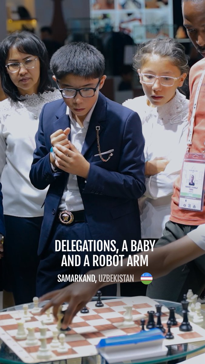 A young boy in a suit and glasses playing chess, with the caption 'DELEGATIONS, A BABY AND A ROBOT ARM' and location 'SAMARKAND, UZBEKISTAN' overlaid.