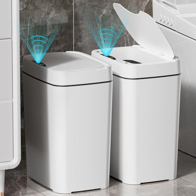 A 2-pack of white touchless bathroom trash cans shown side by side, one closed and one with its lid open, both featuring automatic sensor technology indicated by blue signal waves. The image directly supports the post by visually showcasing the touchless functionality that makes the pair a convenient bathroom upgrade.