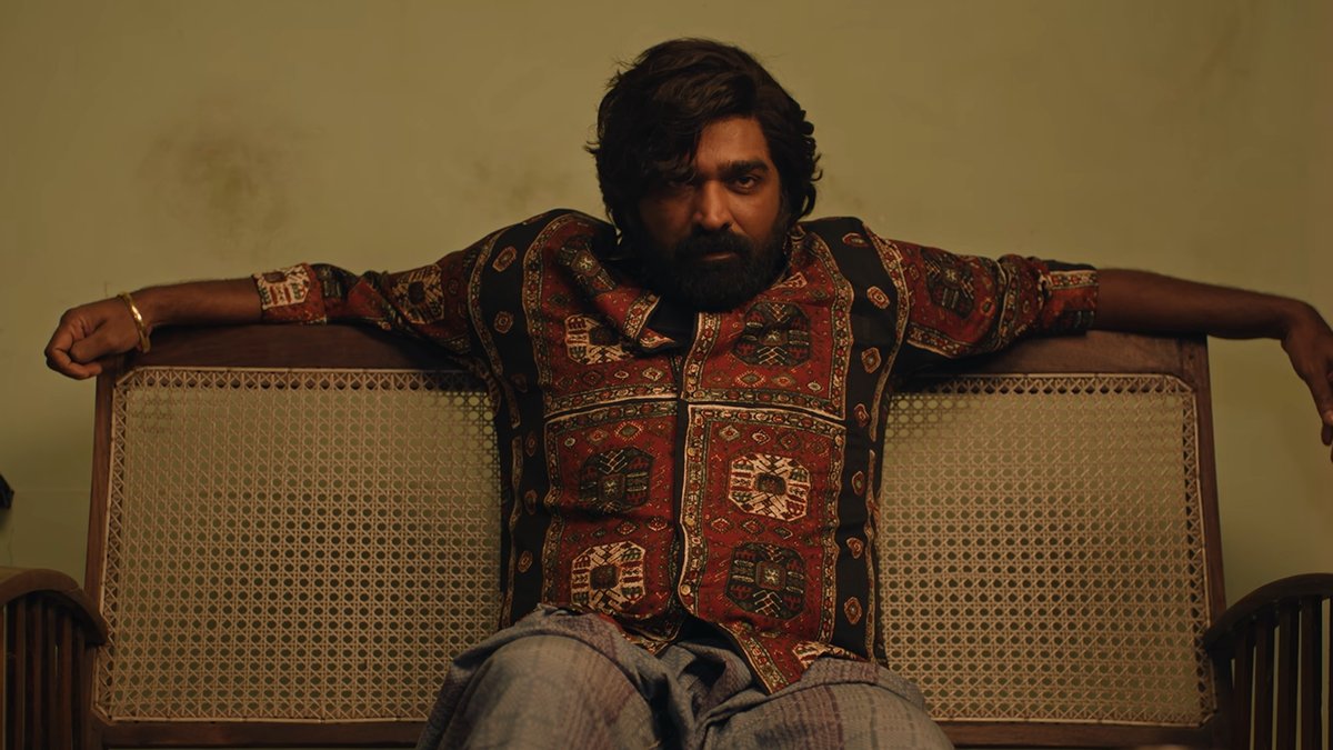 sudhirsrinivasn's tweet photo. Mannnyyyy, mannnyyy thoughts on #Baththa (possible spoilers, as always):
_____

Baththa, played by Vijay Sethupathi, is a frightening gangster. He is driven by ego, and no threat scares him. At home, he casually slaps his wife, throws a plate full of food, yells at his daughter. And he seems to be getting away with everything. So, you really wonder who's gonna put him in his place. Balaji Tharaneetharan's film hints that an assassination attempt is on the cards. But as it turns out, Baththa's most dangerous adversary is not a gangster, not some man who defeats him in size and strength. Instead, it's the opposite. His reckoning comes in the form of a little, meek boy.

Baththa is full of such gorgeous ideas. The tender beauty of a child’s innocence serving as a mirror to such a gangster feels almost like a 'pure cinema' idea. For an entire half, Baththa is stuck in a school toilet, isolated and unable to get out. The premise seems almost like it might potentially get a bit too indulgent, a bit too static, maybe test your patience a bit. But Balaji's Baththa is magnificently kinetic.

And I think it's because Baththa is so cleverly written. It's got all these suspense lifelines that power the whole film: Will Sabari ever open the toilet door? Once you get the answer to that, will Sabari ever confess to Baththa? Once that gets answered, there’s another question waiting: Why did Baththa even enter this isolated toilet in the first place? The beauty of Baththa is how it comes with such heartwarming moving answers to each question. And it shows such mastery over how long to keep the suspense alive and when to provide you with the answer.

There are all these deep, psychological undertones that make this film feel so wise, and yet, so simple. The loss of innocence. The impact of bullying. The origin of malice. Baththa is about all of that, but the film is loving enough to remember that every adult was once a boy, perhaps still is. When Baththa has a moment with little Sabari, he reminisces, “I was also like you at one point.” And it's beautifully cyclical that the innocence, goodness, call it what you will, can only be regained when in the presence of a pure life form. Like in Meiyazhagan. Here, of course, it's a little boy.

I love it when films like Baththa allow for many metaphorical readings organically. That gorgeous shot of Baththa peeking out through a tiny hole in the toilet door says so much beyond words. The toilet itself feels like the stinking prison that his life seems to have become. Can Baththa find it in him to escape it? And I love that this film does it by asking an essential, but too-often ignored question. In a world where adults are constantly obsessed with teaching children, can they take a step back, and instead, learn? It feels like all of us were born perfect, and the world somehow made us lose our way.

I was astonished at how Balaji Tharaneetharan strikes a balance between humour and poignant emotion. The humour is sometimes in repetition (“Nee yenda school toilet-ku pona?”), but it’s also in Vijay Sethupathi’s expressions as he suffers. He’s tremendous in this film, particularly in the way he channels vulnerability, and in how quickly, he turns that into dry humour. Watch him beg for poignantly freedom, bringing up his daughter and wife. I cried. And then, almost immediately, I laughed as the film focusses on the abusrdity of a paper full of porai being pushed towards him from under the door.

The police may not ever get to arrest Baththa for his crimes, but does it matter? This film, and the ingenious situation it throws Baththa in, ensures that he suffers a solitary-confinement sentence that breaks and reforms him in a way. Think about it. His food gets sent under a door. The little warden turns up once in a while. Baththa's freedom is curtailed by a door he cannot easily break. Right in the beginning, you see that his power means nothing. The man who cannot be contained by rivals, police or even family, is contained by a huge toilet, and more importantly, by the terror of a child. The irony is, if Baththa had asked nicely, he would never have had to suffer.

There’s something else the film keeps returning to: the catharsis offered by a family. Almost everyone here seems to be motivated by one. A gangster becomes a villain because he was beaten up in the presence of his family. A little boy is frightened because he thinks his mistake might result in his parents being murdered. Baththa bargains for freedom by invoking his wife and daughter. So, it's quite fitting that a family function eventually becomes the setting in which gangsters heal. It all reminded me of a line from a Sai Abhyankkar song: “Karunaye kudumbama theriyudha?” We've seen so many films where the hero saves a family. In Baththa, a family saves the hero.

And I thought this all connected beautifully to the film’s idea of courage. Is courage beating people up? Is it inspiring fear? For a while, you’re wondering what Baththa thinks of Sabari’s father, because the man is presented as docile. Sabari’s mother even tells the boy, almost as a complaint, that he’s behaving exactly like his father. Yet this supposedly meek man, even at the cost of what the world might perceive as emasculation, performs a tremendous act of kindness. Baththa is shocked. Here is a man seemingly without power doing something the all-powerful gangster could not comprehend.

But the film’s greatest act of courage comes, fittingly, not from any of these men. It comes from the boy. At risk to himself, fearing mortal danger to his family, terrified of what might happen next, this little boy still ventures into the dark every day to face a monster. And at one point, the boy even releases the monster. He does this despite believing that he might get killed. It's the kind of courage adults are rarely capable of. And yet, it comes so naturally for this boy. I was truly wowed and moved.

It’s such a cleverly written film too. It shows you a snake and creates the expectation that surely the snake is going to do something. Instead, something else happens. Balaji Tharaneetharan ensures that there simply isn’t a dull moment here. Even when Baththa and the boy go shopping for a family function (exactly the sort of stretch in which you could forgive a film for taking a breather and throwing in a generic montage), it’s still channelling humour. It’s still finding little ways to establish the period, with talk of ‘safari suits’, for instance.

And the boy, Sai Prithviraj, is so good. You realise it particularly after he finally sheds that frightened-boy expression and begins to smile. It really feels like a dam finally allowing water to flow. I was a real goner during his confession, as he tears up and chokes and then slowly finds the confidence to keep going with his story. I also loved Lijomol Jose as Baththa’s wife, particularly in that scene after he returns home and begins eating her food. She doesn’t react with joy. At first, she looks almost like she isn’t sure whether what she’s seeing is really happening. Is this really the same man? And then, when she finally allows herself to believe it, she begins throwing in more and more spoonfuls of chutney. And that's enough.

And then, just when I thought that everything seemed resolved and all tensions had eased, this gorgeous film somehow finds more oxygen. Because what needed to be saved wasn't just Baththa, but the origins of his pain. And so, you get this moment where there's an audience, and after a while, you can see that Balaji Tharaneetharan has set up the film in a way that it's gonna end up with a whole group of people clapping. But the difference Baththa has with other films is, here, we also become Baththa's audience. The clapping, then, happened organically for me because the film understands that what really moves us, what truly saves us, isn't talent or power. It's far simpler and almost cliche: genuine wide-eyed love for another. I think that's what I felt for Baththa, as I walked out of the theatre wiping my eyes.