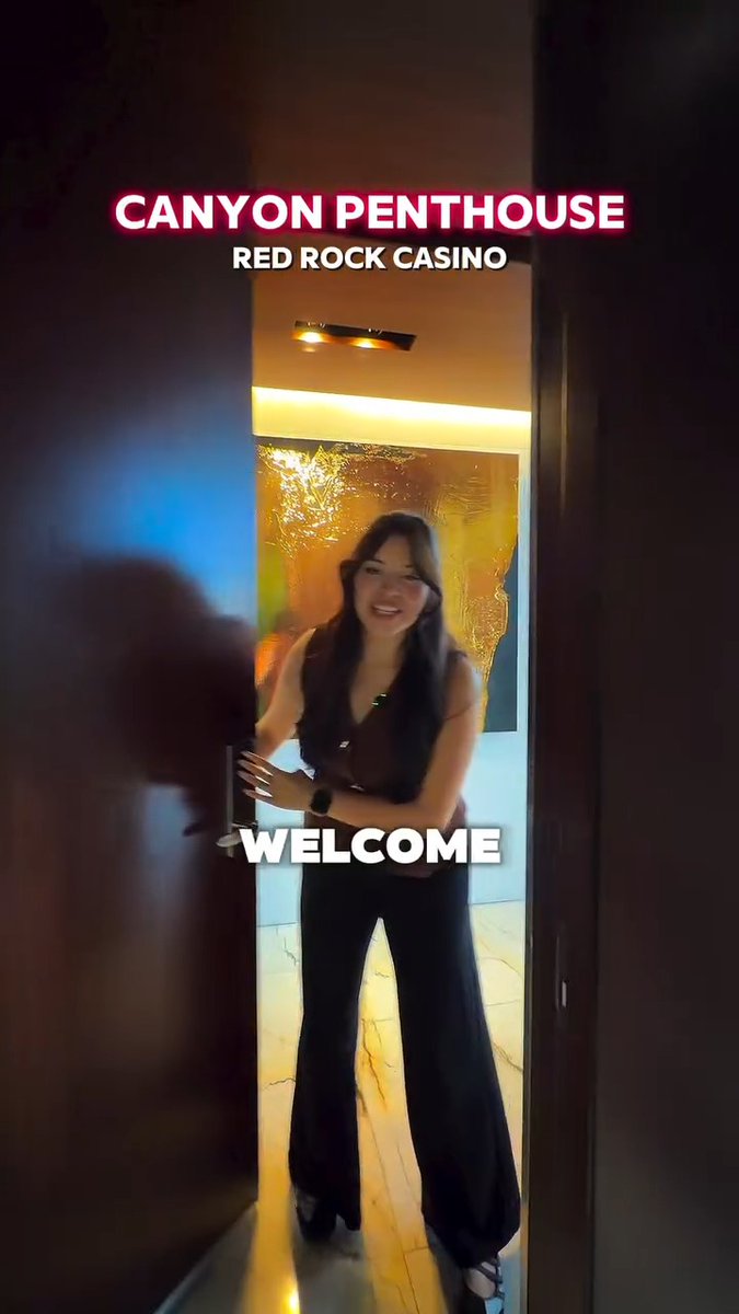 A smiling woman in black pants and a brown top stands in a doorway with text overlay reading 'CANYON PENTHOUSE RED ROCK CASINO' and 'WELCOME'.